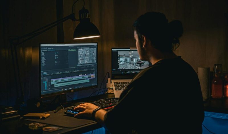 A web designer working on a laptop, showcasing the creative process behind crafting visually stunning and user-friendly websites.