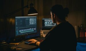 A web designer working on a laptop, showcasing the creative process behind crafting visually stunning and user-friendly websites.